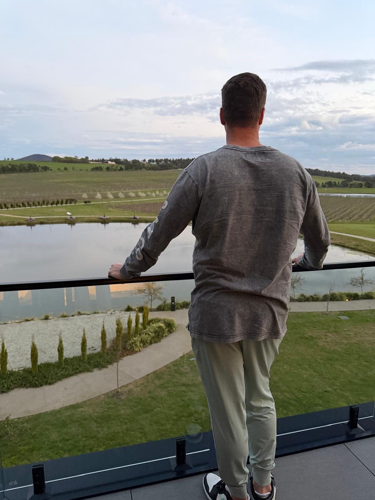 Damian Burstow on a balcony looking out over a vineyard